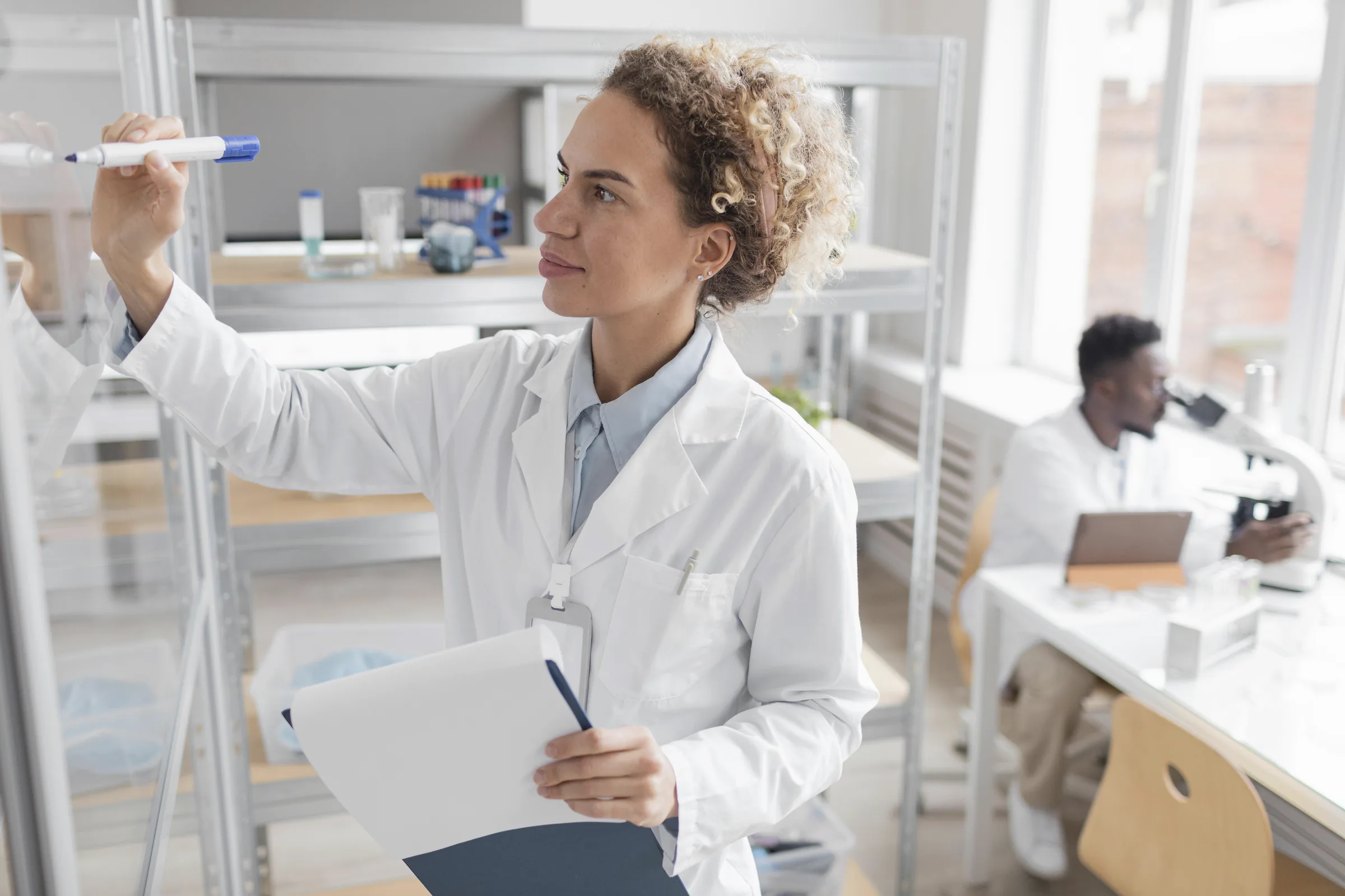 Research professional reviewing documentation in a biotechnology laboratory